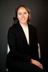 Headshot of Kate Marzen. She is wearing a black jacket over a white blouse.