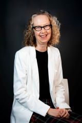 Portrait photo of CTLE director Jessamyn Neuhaus. She is wearing a white jacket over a black shirt.